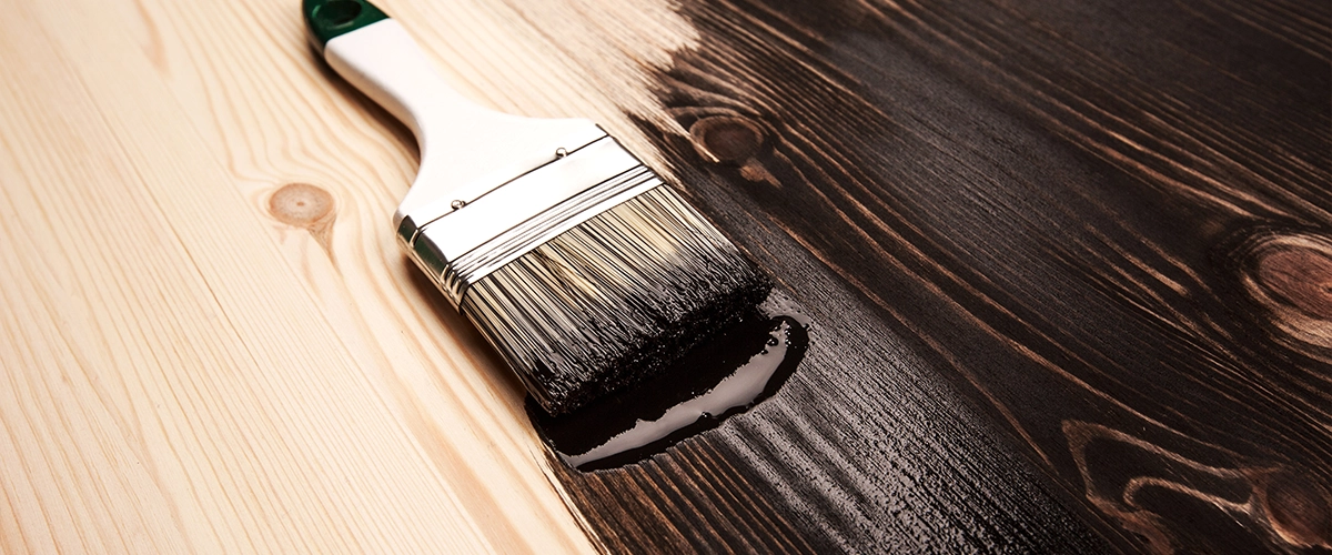 Applying black paint with a brush