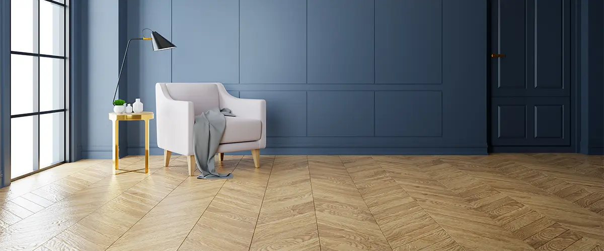 Herringbone design on a wood floor with dark blue walls