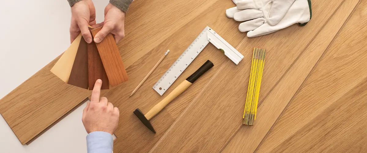 Man choosing between multiple options of prefinished hardwood flooring