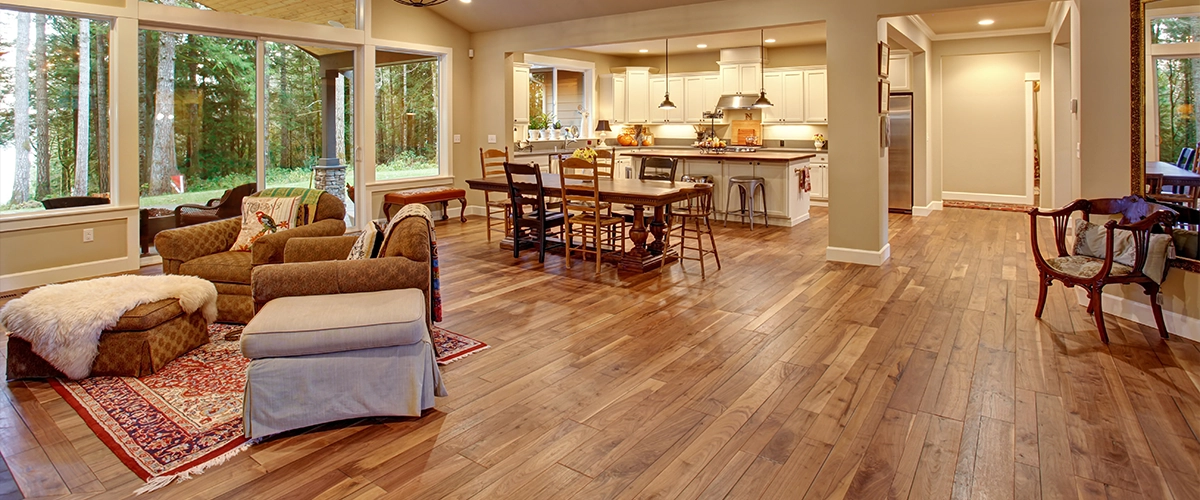 A large open-space kitchen with hardwood flooring