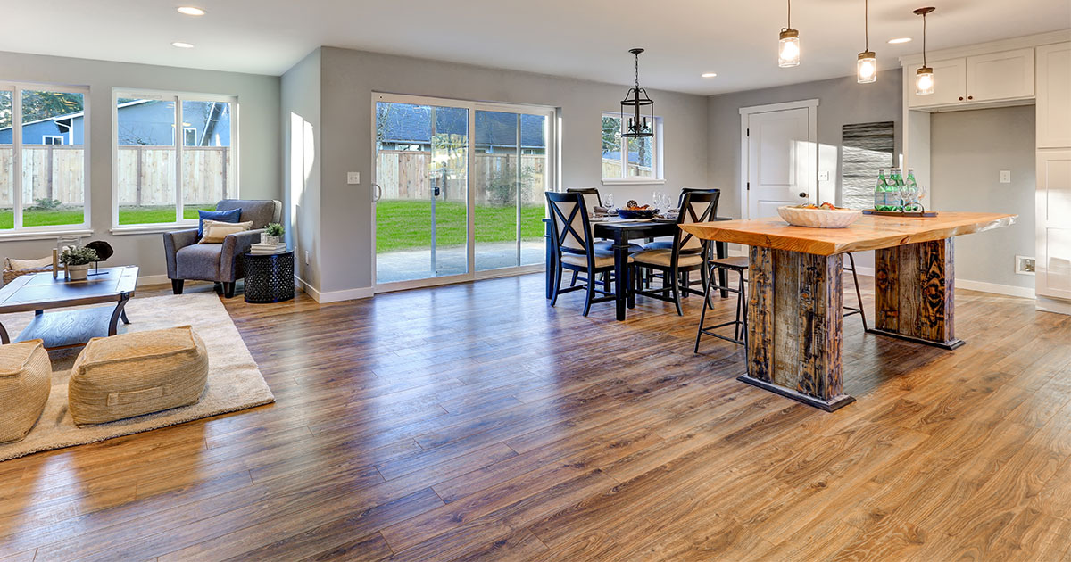 A hardwood flooring in a kitchen with a wood island