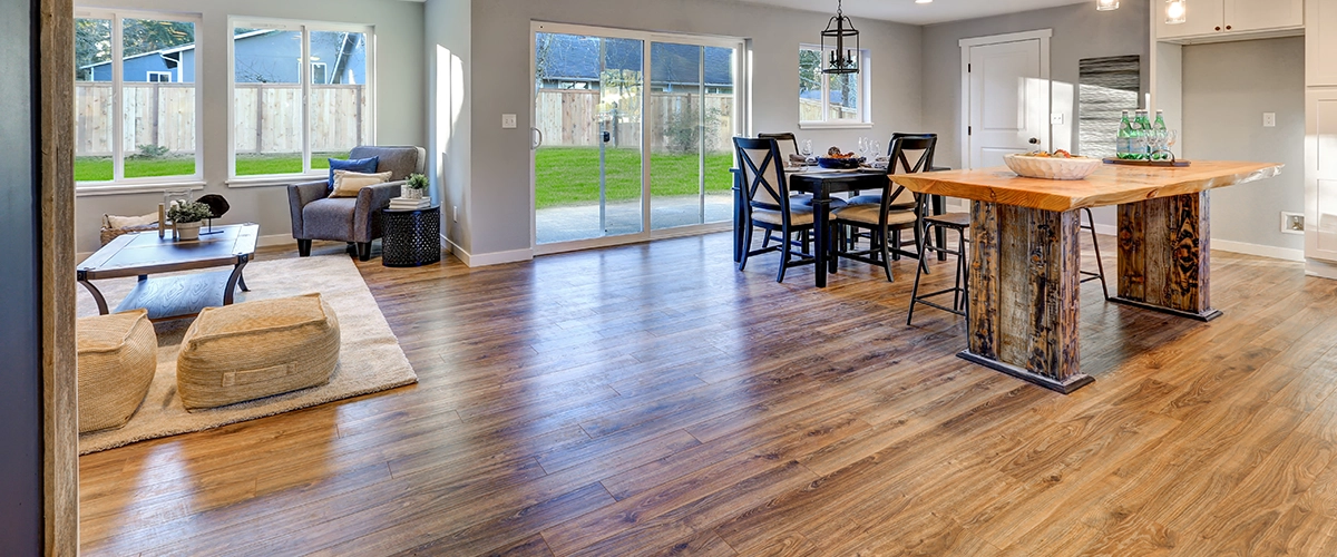 A hardwood kitchen flooring in a kitchen with a wood island