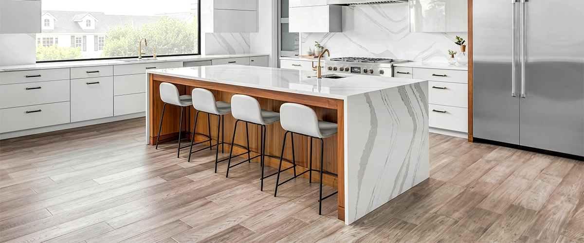 A luxury vinyl plank flooring with a marble island