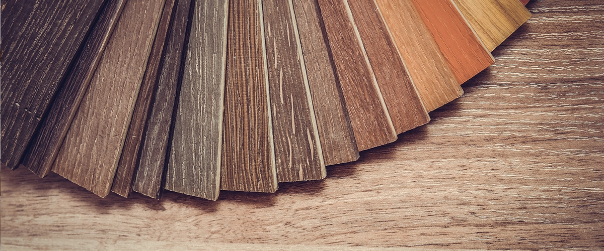 Solid hardwood samples spread on the floor