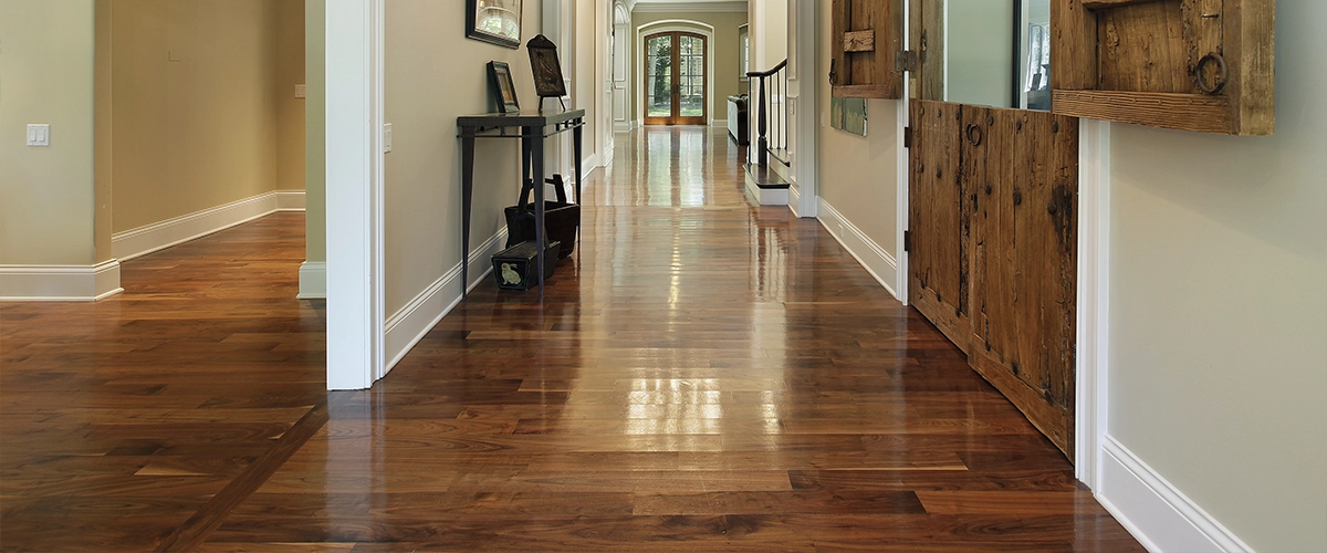 A shining hardwood floor in a long hallway
