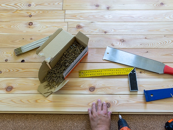 Flooring contractor installing unfinished hardwood flooring