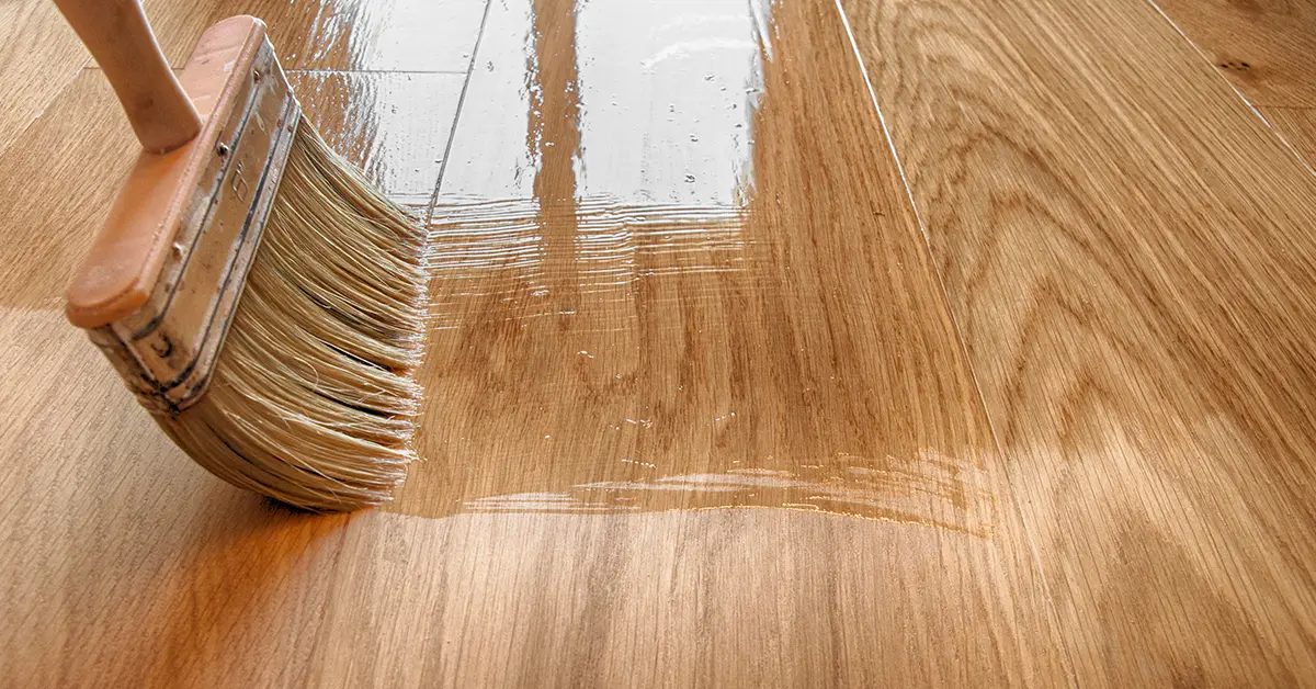 Applying oil to hardwood floors using a soft brush