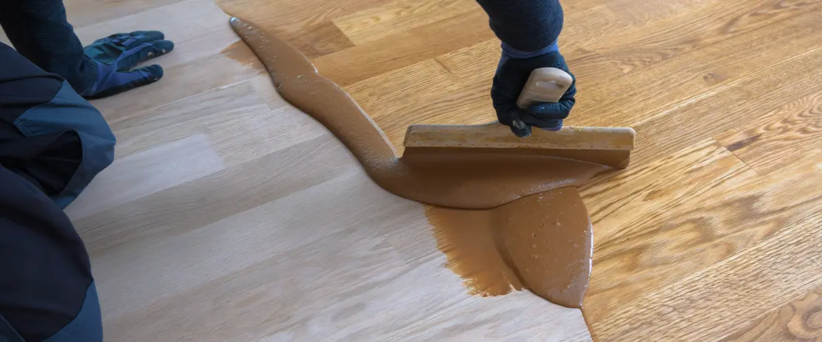 A hard wax oil finish being applied on a wood floor