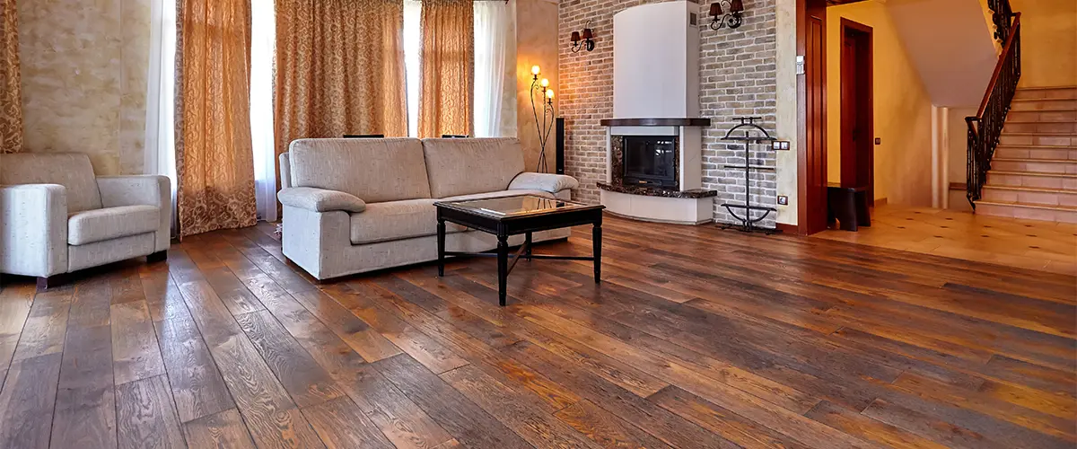 A hardwood floor refinishing in Mount Pleasant in a living room with a beige couch