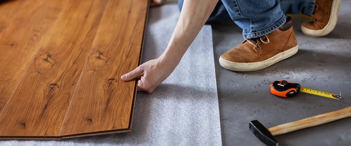 Man installing engineered wood floors