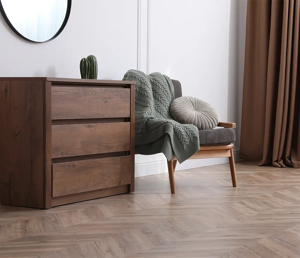 A hardwood floor with herringbone design and wood furniture
