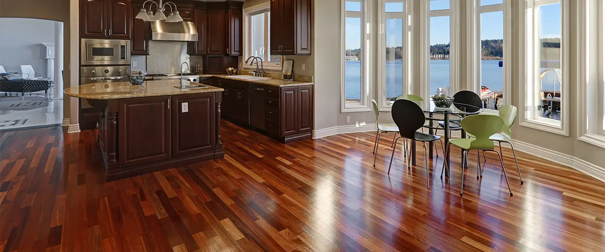 Replace hardwood floors in an open-concept kitchen with stools and a plastic table