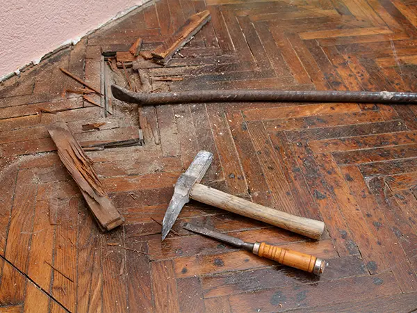 A chisel and hammer on a very old wood floor
