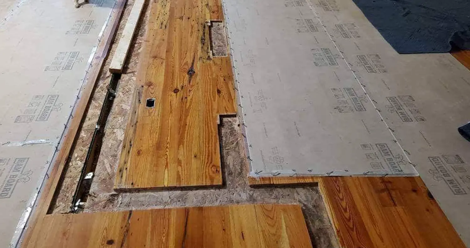 Damaged floor removing rotten boards and replacing