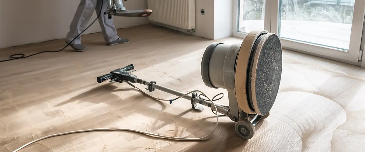A big sanding machine on a wooden floor