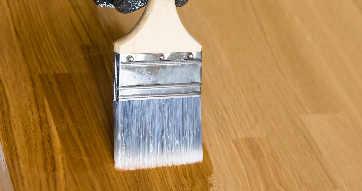 Paint brush sealing wood floor surface