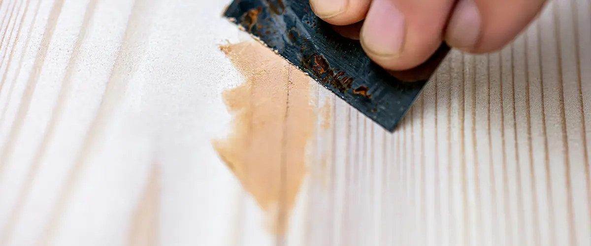 Applying wood filler before resurfacing wood floor
