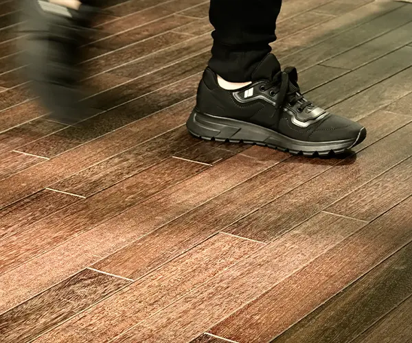 Man walking on wood floors with shoes on