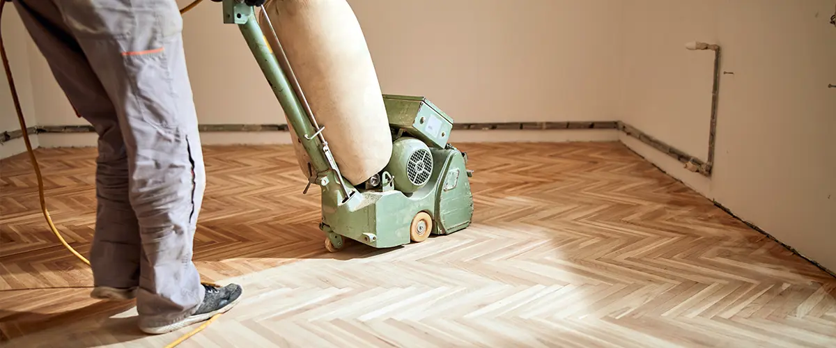 Sanding a wood floor with heavy machinery